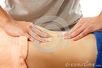 Masseur makes belly massage young woman on white Stock Photo