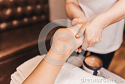 Masseur massages active points on the feet - foot massage Stock Photo