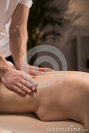 Masseur massaging naked woman Stock Photo