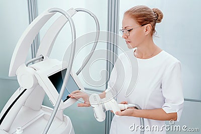 The masseur is preparing to make an hardware lpg massage in a beauty salon Stock Photo