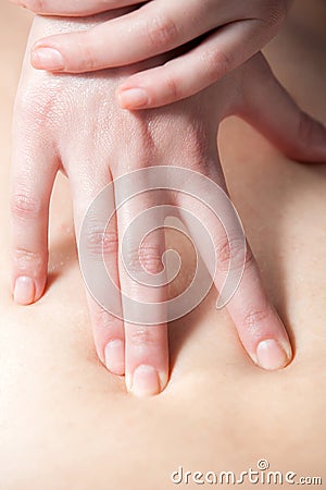 Masseur's hands doing deep tissue massage Stock Photo