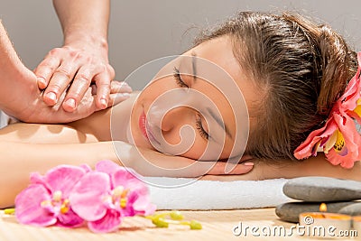 Masseur`s hands doing massage shoulder Stock Photo