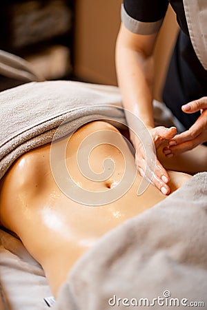 Masseuse performs professional abdominal massage for a woman Stock Photo