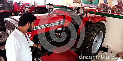 tractor presenting by honda automobile salesmen at showroom in India Editorial Stock Photo
