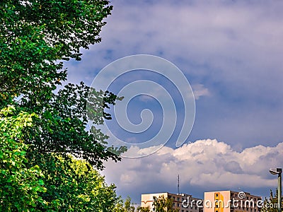 Massive clouds above the houses in the distance on the blue sky Stock Photo