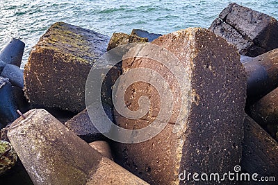 Massive concrete breakwaters to protect the coast from the destructive effects of sea waves Stock Photo