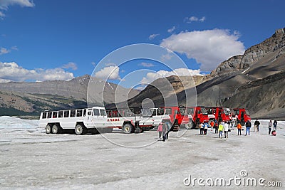 Massive Ice Explorers, specially designed for glacial travel, take tourists in the Columbia Icefields, Canada Editorial Stock Photo