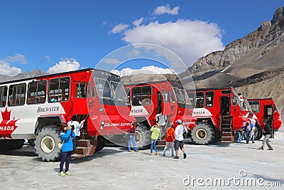 Massive Ice Explorers, specially designed for glacial travel, take tourists onto the surface of the Columbia Icefields, Canada Editorial Stock Photo