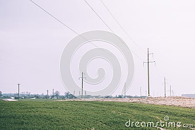 Mast electrical power line in field on a sunny day. High voltage pole Stock Photo