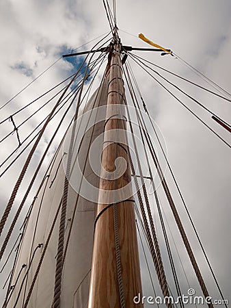 Mast, ropes and sails collected from an old sailboat seen from below Stock Photo