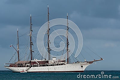 4 mast tall ship anchored with a tender boat in the port of Cozumel, Mexico Stock Photo