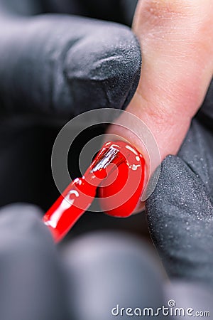 Master applied varnish drawing on nails gel in manicure salon, close-up. Gel polish concept. Stock Photo