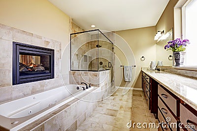 Master bathroom in modern house with fireplace and tile floor Stock Photo
