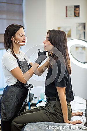 Master of beauty make permanent make up for eyebrows Stock Photo