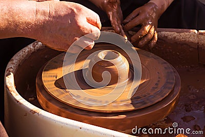 Master class in making a jug from clay, an adult teacher teaches a child to make clay products Stock Photo