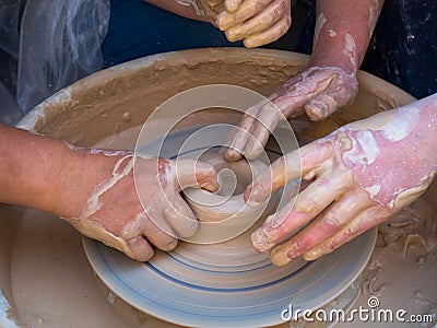 Master class on modeling of clay on a potter`s wheel In the pottery workshop for children sunny day Stock Photo