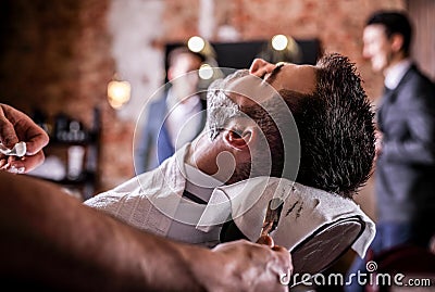 Master makes beards correction in barbershop salon. Close up photo. Stock Photo