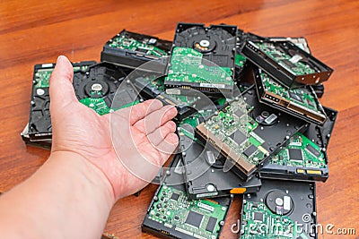 Master points his hand at a bunch of old and dusty hard disks Stock Photo
