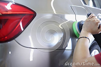 Master polishing car using special machine closeup Stock Photo