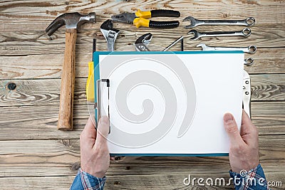 Master repair hands holding paper Stock Photo