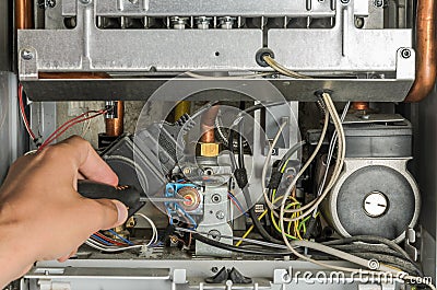 The master repairs the electronic part of the gas heating boiler Stock Photo