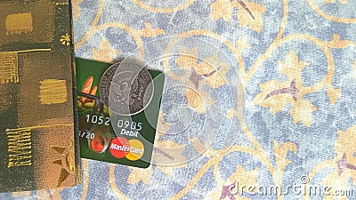 MasterCard bank card and half dollar coin Editorial Stock Photo