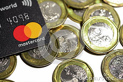 Mastercard credit card and singapore dollar coins. Financial and bank credit concepts Editorial Stock Photo