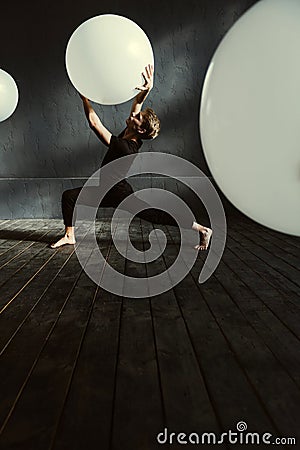 Masterful dancer performing in the dark lighted room Stock Photo