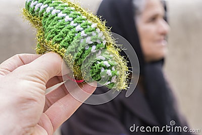 Close Up view of a small woolen socks with blurred woman Editorial Stock Photo