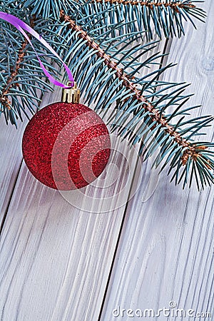 Mat red christmas ball and pinetree branch on white wooden board Stock Photo