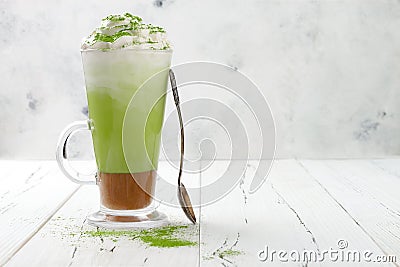 Matcha latte with salted caramel in tall glass. Stock Photo