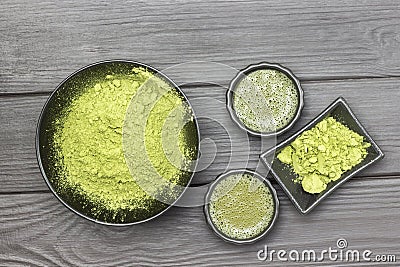 Matcha tea in two bowls. Green matcha tea powder in black bowl. Flat l Stock Photo