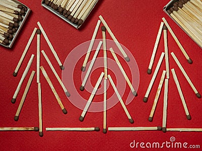 Matches on a red background. Safe handling of fire. Fire dangers. Lots of matches. Pictures lined with matches. Trees of matches Stock Photo