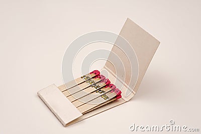 Matchsticks with faces painted on the heads on white on white Stock Photo
