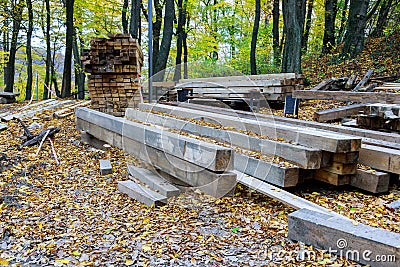 Material for the construction of wooden building stack of wooden square beams for construction Stock Photo