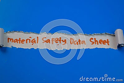 Material Safety Data Sheet Text written in torn paper Stock Photo