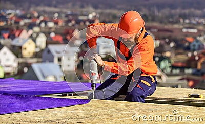 Materials requirements. Install partially overlapping layers of material over roof insulation surfaces. Master repair Stock Photo