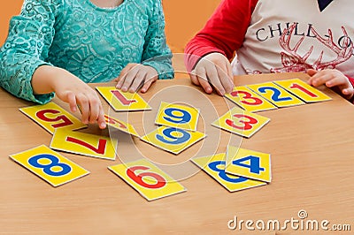Math lesson in elementary school. Kids are playing. Educational games. A child in kindergarten. Hands of a child. Math Stock Photo