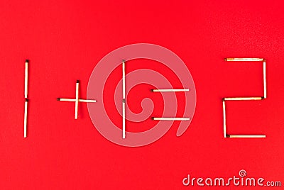 Mathematical addition of numbers using matches on red background Stock Photo