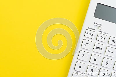 Mathematics, tax calculation, finance or investment concept, white clean calculator on solid yellow background with copy space Stock Photo