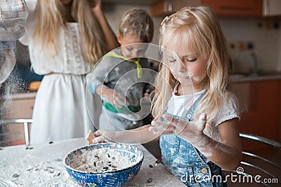 Mather daughter and son haveing fun on a kitchen Stock Photo