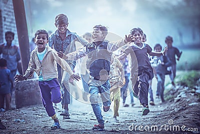 Group of boisterous Indian children running for photograph in Agra, Uttar Pradesh, India Editorial Stock Photo