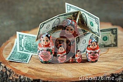 Matryoshka art. Russian doll with dollars. Anti crisis money box. Stock Photo