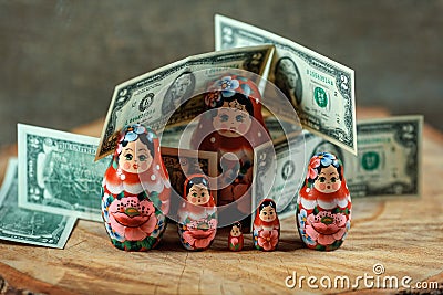 Matryoshka. Russian doll with dollars. Anti crisis money box. Stock Photo