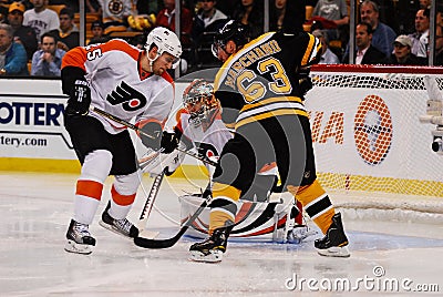 Matt Carle and Brad Marchand battle for puck. Editorial Stock Photo