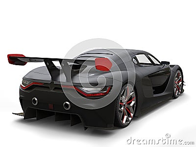 Matte black super car with big rear wing with red sides Stock Photo