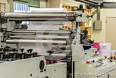 Matte or gloss plastic machine in a printing press for a perfect finish of printed documents. Stock Photo