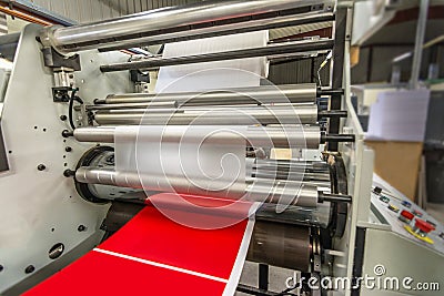 Matte or gloss plastic machine in a printing press for a perfect finish of printed documents. Stock Photo