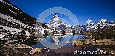 Matterhorn Peak reflection in summer at Riffelsee lake, Gornergrat station, Zermatt, Switzerland Editorial Stock Photo