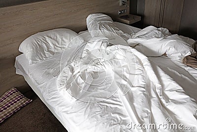 Mattress bed white sheet, duvet and pillow, messed up Stock Photo